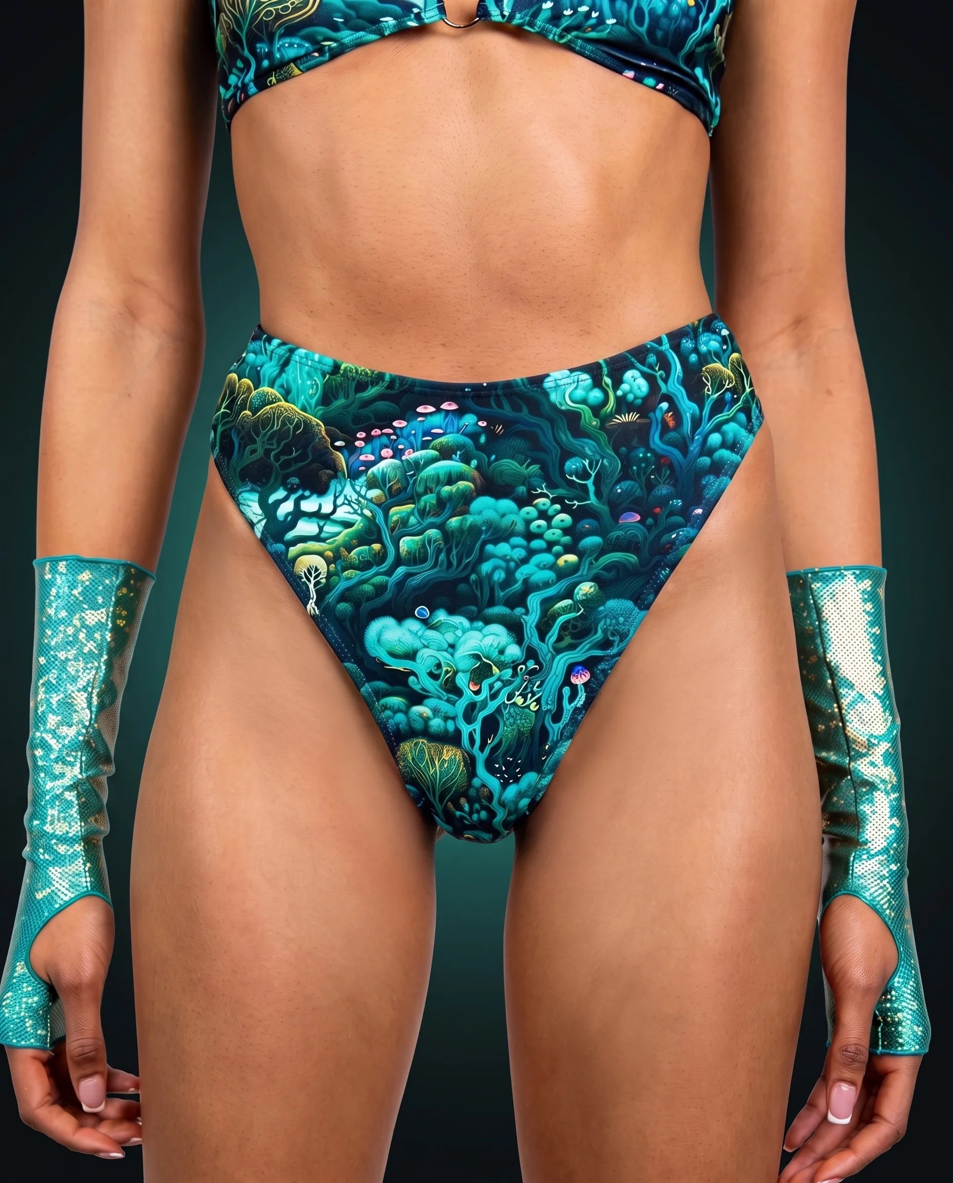 Front view of the Faewood High Waisted Thong, a teal enchanted forest print, worn with teal shimmer gauntlets