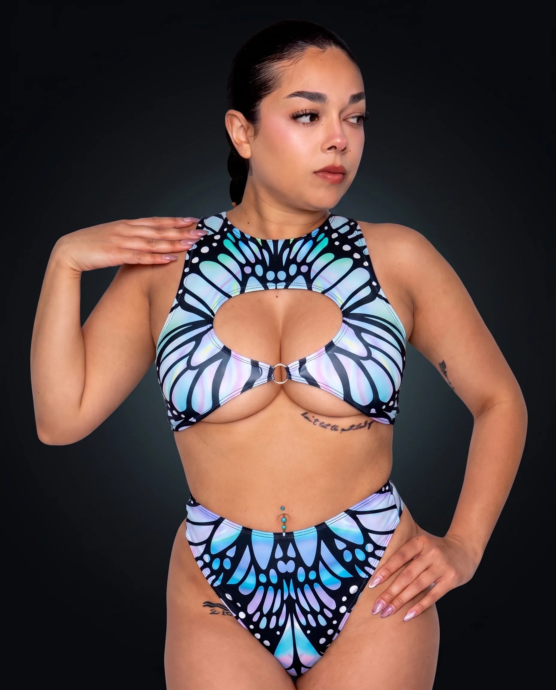 Model wearing the Gossamer Keyhole Top and matching bottoms, a pastel holographic butterfly wing print