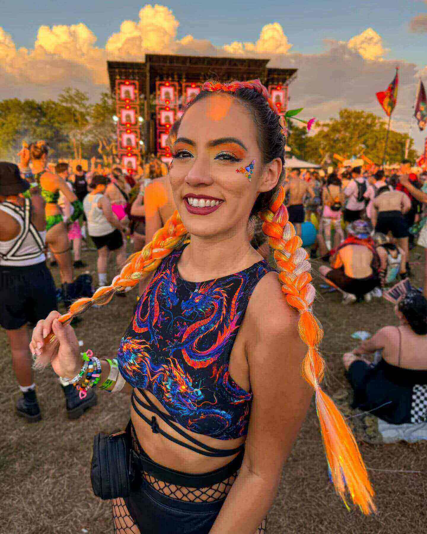 A festival-goer in a vibrant dragon-print <a href=